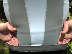 Lower inner foam-like band located at rear of shirt keeps it in place