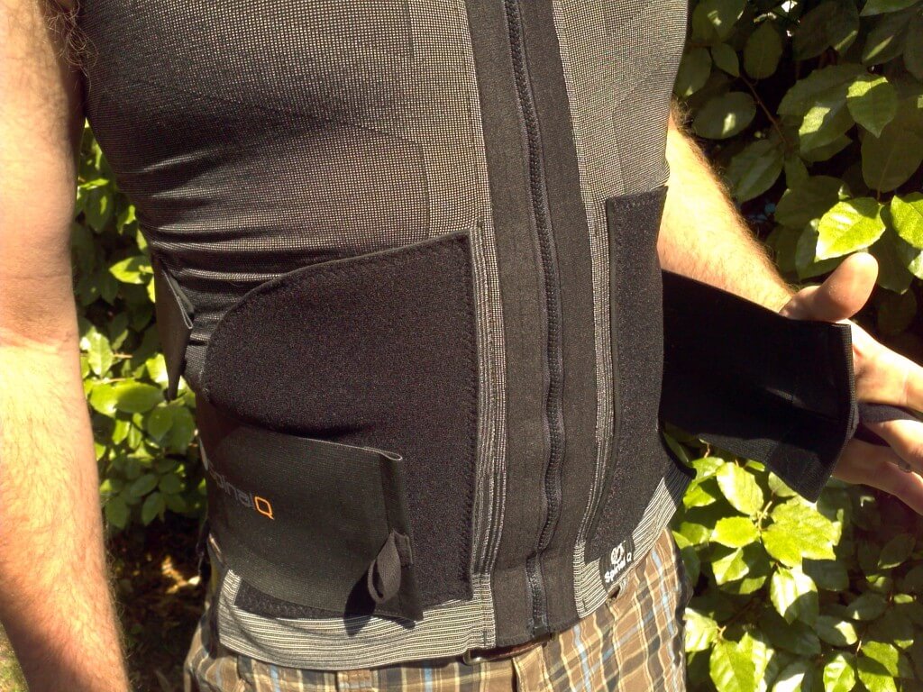 After zipping up, secure the lumbar strap on each side