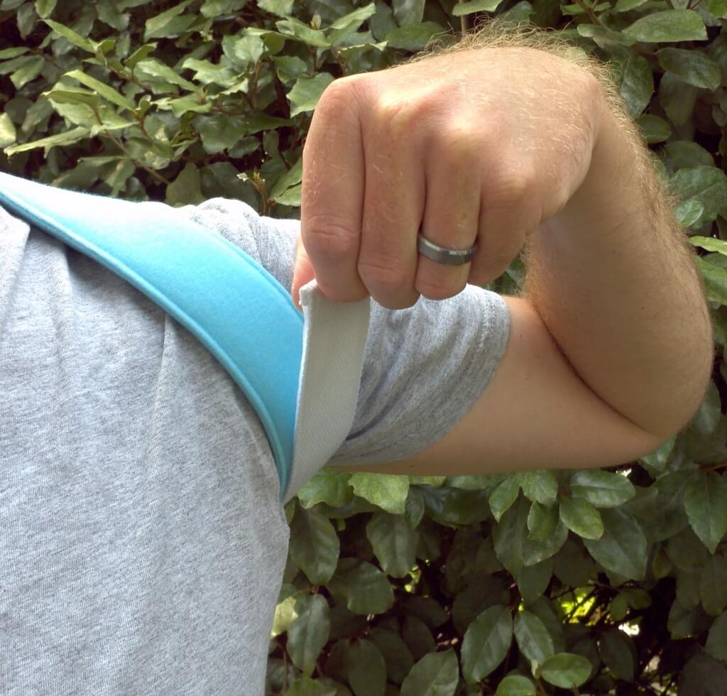 Pull adjustment strap to move shoulders back to a comfortable position